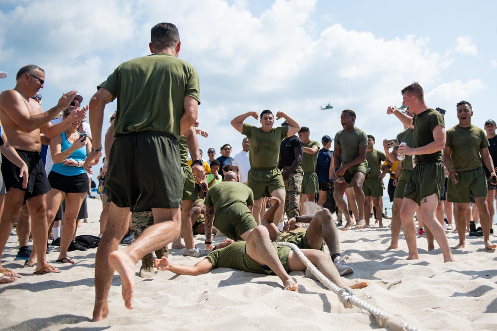 U.S. Marines celebrate winning a game of tug-of-war during the “Top Gun” Beach Olympics event in Miami Beach, Fla., during Fleet Week Miami, May 11, 2024.