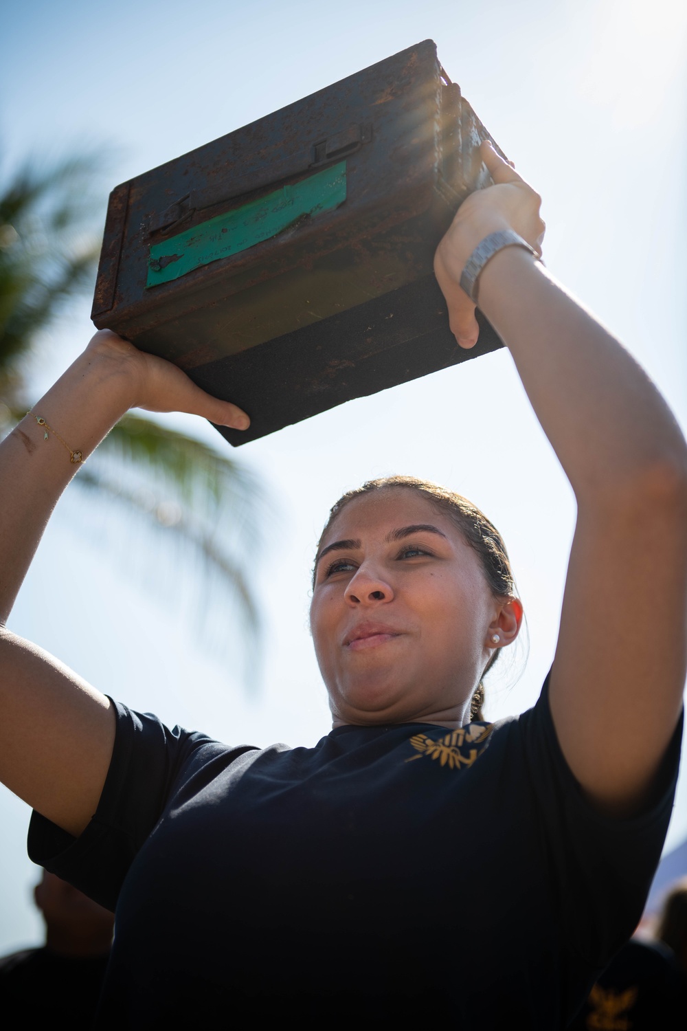 U.S. Navy Aviation Electronics Technician 2nd Class Rebecca Filgueiras, from Boca Raton, Fla., competes in an ammunition box pick-up contest during the “Top Gun” Beach Olympics event in Miami Beach, Fla., during Fleet Week Miami, May 11, 2024.