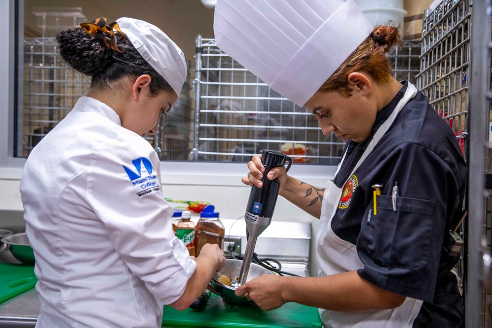 U.S. maritime servicemembers participate in a “Galley Wars” cooking competition at Miami-Dade College