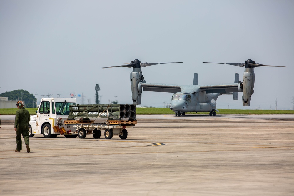 U.S. Marines with VMM-265 transport HIMARS ammunition pods with MV-22B Osprey