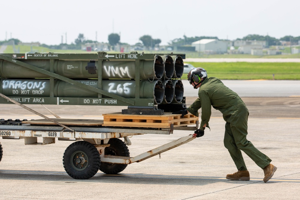 U.S. Marines with VMM-265 transport HIMARS ammunition pods with MV-22B Osprey