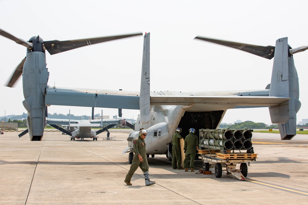 U.S. Marines with VMM-265 transport HIMARS ammunition pods with MV-22B Osprey