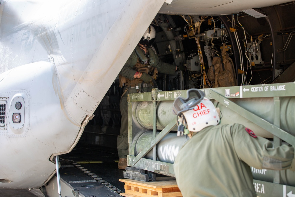 U.S. Marines with VMM-265 transport HIMARS ammunition pods with MV-22B Osprey