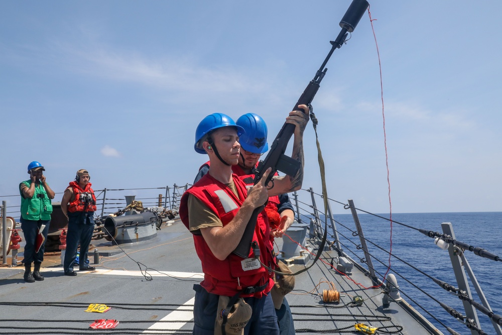 Sailors aboard the USS Howard conduct a replenishment-at-sea with the USNS John Ericsson in the South China Sea