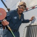 Sailors aboard the USS Howard conduct maintenance on the ship's exterior bulkhead in the South China Sea