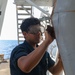 Sailors aboard the USS Howard conduct maintenance on the ship's exterior bulkhead in the South China Sea