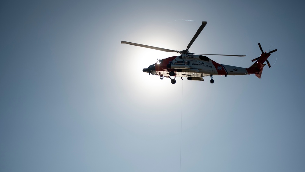 Coast Guard MH-60 Jayhawk and MH-65 Dolphin helicopter aircrews train near North Head Lighthouse in Cape Disappointment State Park, Washington