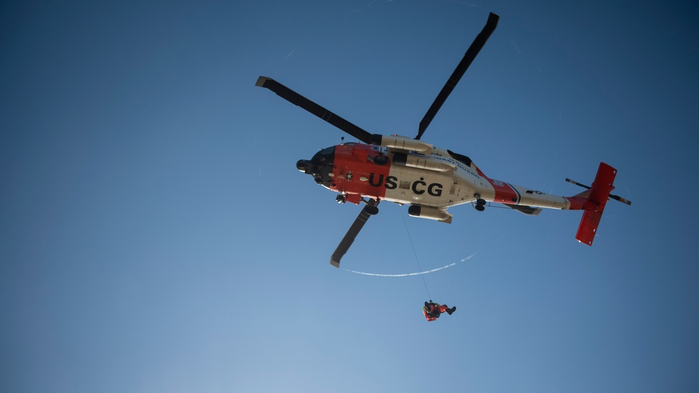 Coast Guard MH-60 Jayhawk and MH-65 Dolphin helicopter aircrews train near North Head Lighthouse in Cape Disappointment State Park, Washington