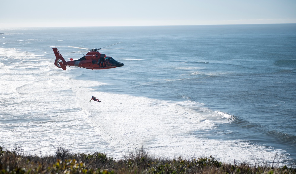 Coast Guard MH-60 Jayhawk and MH-65 Dolphin helicopter aircrews train near North Head Lighthouse in Cape Disappointment State Park, Washington