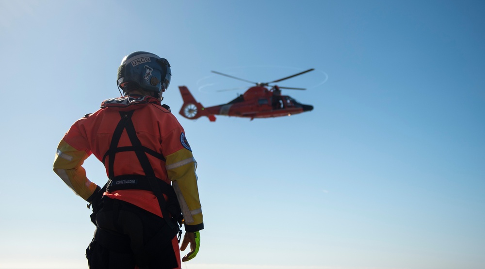 Coast Guard MH-60 Jayhawk and MH-65 Dolphin helicopter aircrews train near North Head Lighthouse in Cape Disappointment State Park, Washington