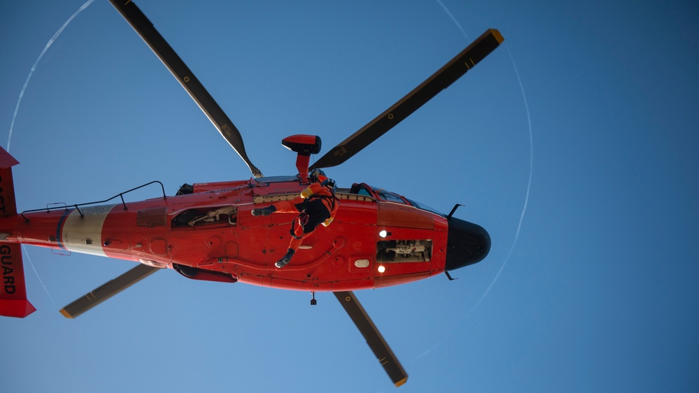 Coast Guard MH-60 Jayhawk and MH-65 Dolphin helicopter aircrews train near North Head Lighthouse in Cape Disappointment State Park, Washington