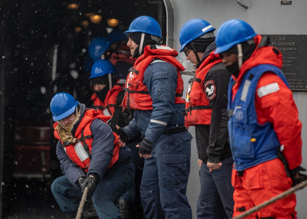 USS Ralph Johnson conducts replenishment at sea.