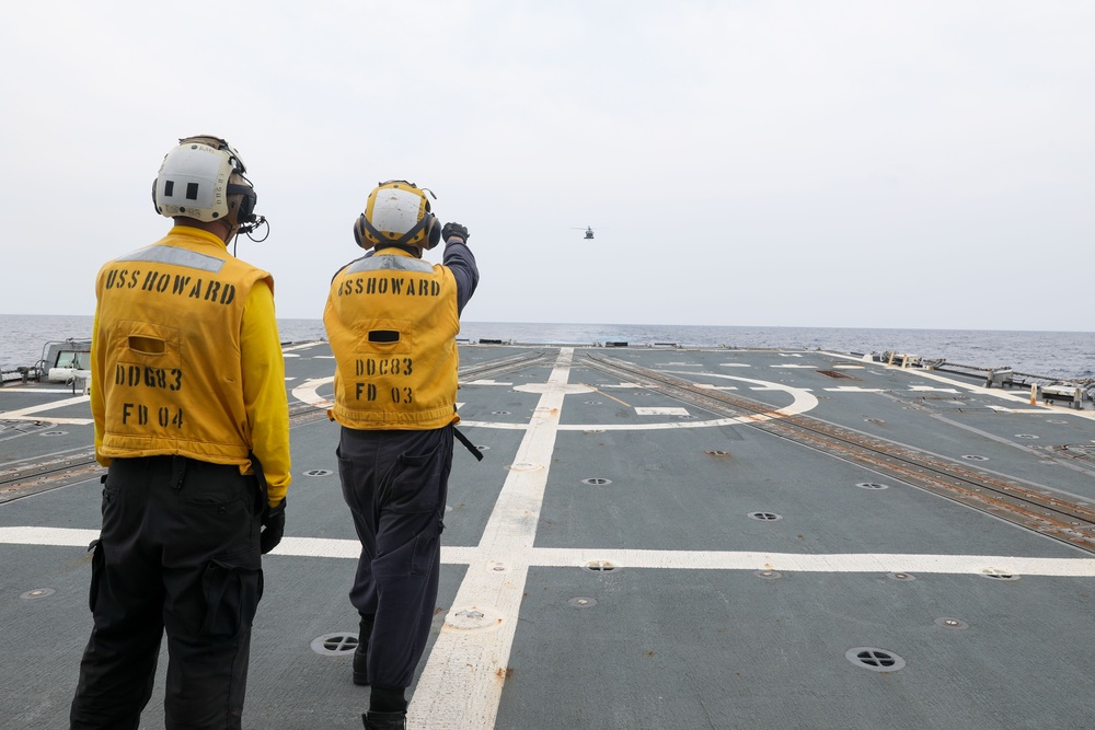 Sailors aboard the USS Howard conduct flight quarters in the South China Sea