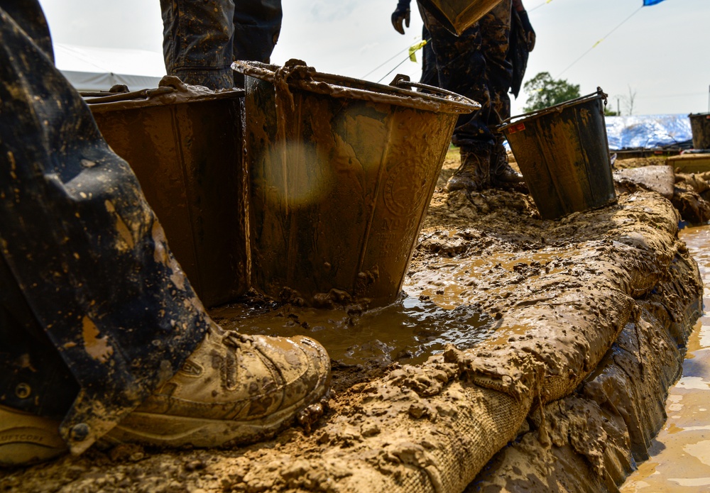 DPAA Personnel Clear Mud From Retention Pond