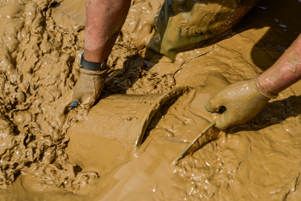 DPAA Personnel Clear Mud From Retention Pond