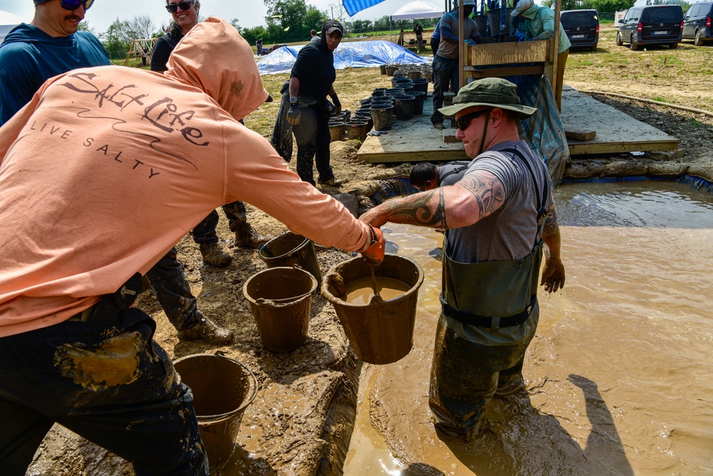 DPAA Personnel Clear Mud From Retention Pond