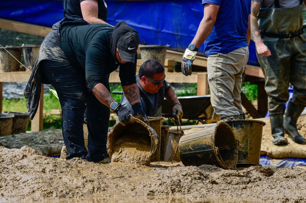 DPAA Personnel Clear Mud From Retention Pond