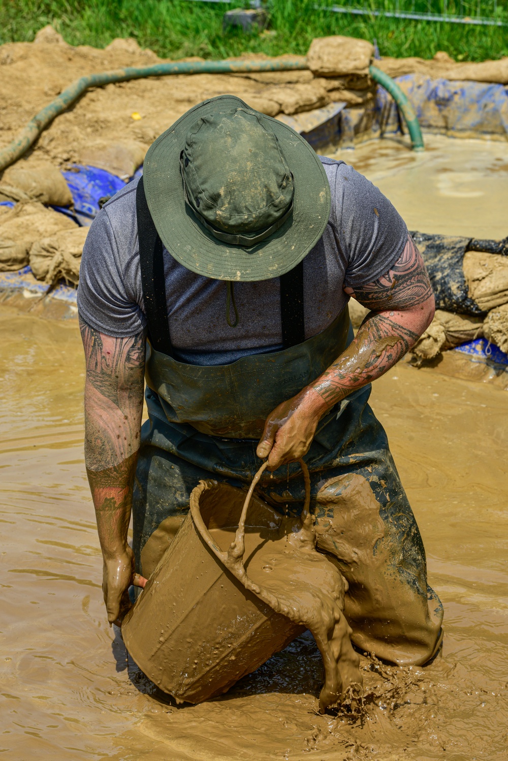 DPAA Personnel Clear Mud From Retention Pond