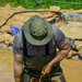 DPAA Personnel Clear Mud From Retention Pond