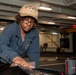 A Sailor conducts restoration efforts in the forecastle of USS Carl Vinson