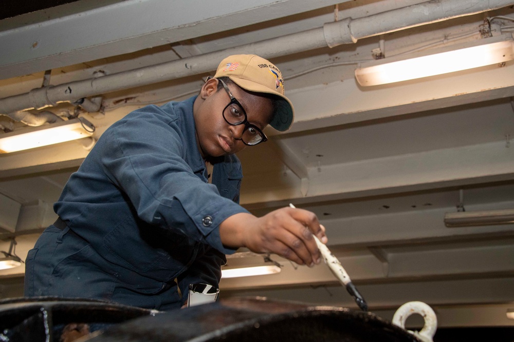 A Sailor conducts restoration efforts in the forecastle of USS Carl Vinson