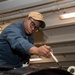 A Sailor conducts restoration efforts in the forecastle of USS Carl Vinson