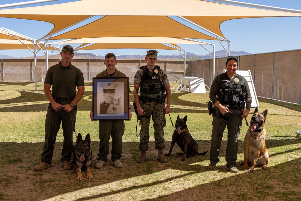 Military Working Dog handlers, their K9s and a photo of Sgt. Cann