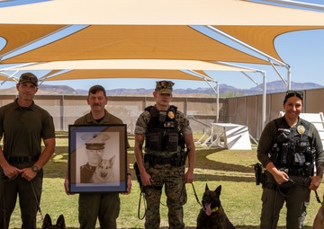 Military Working Dog handlers, their K9s and a photo of Sgt. Cann