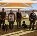 Military Working Dog handlers, their K9s and a photo of Sgt. Cann