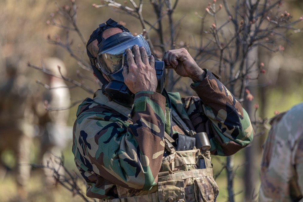 An E3B candidate puts on a gas mask