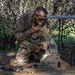 Staff Sgt. Morgan Baker applies camouflage face paint