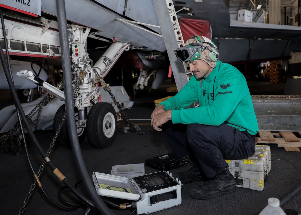 Sailors conduct aircraft maintenance aboard Abraham Lincoln