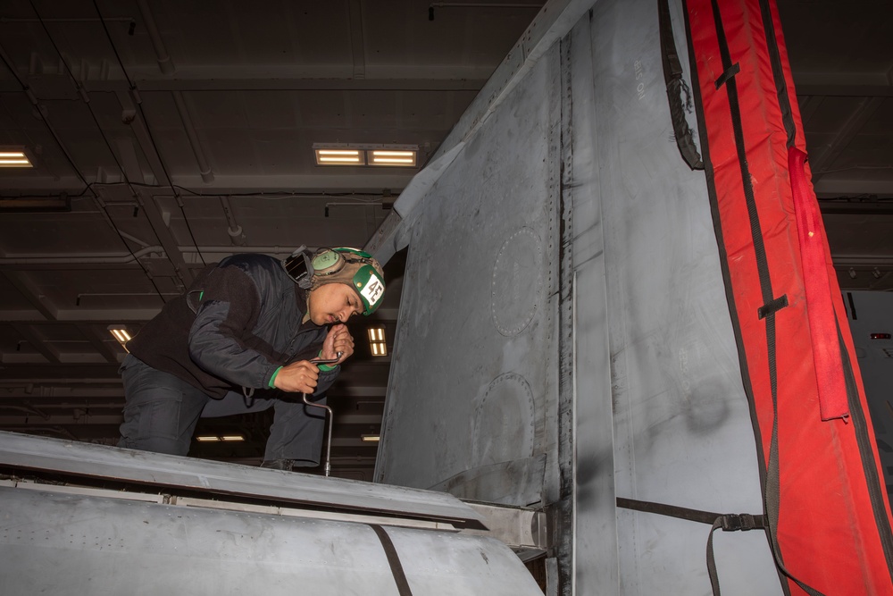Sailors conduct aircraft maintenance aboard Abraham Lincoln
