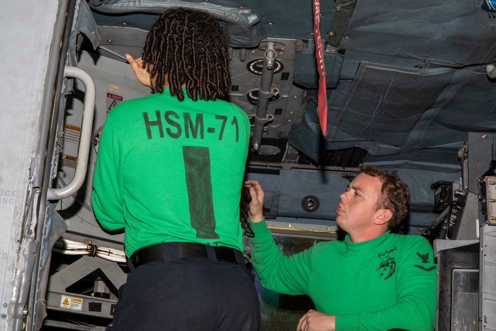 Sailors conduct aircraft maintenance aboard Abraham Lincoln