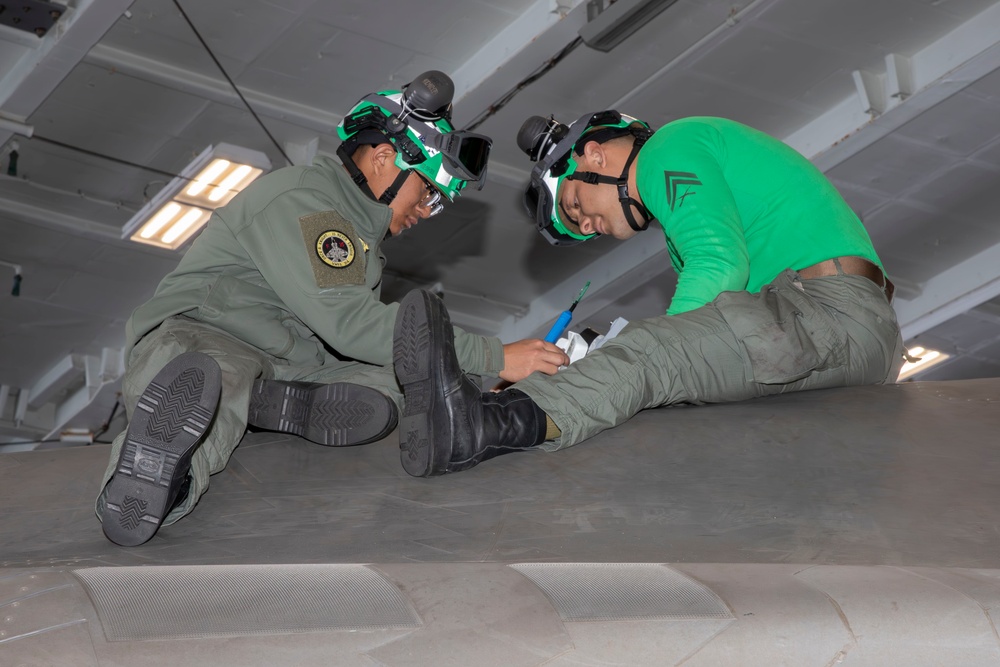 Sailors conduct aircraft maintenance aboard Abraham Lincoln