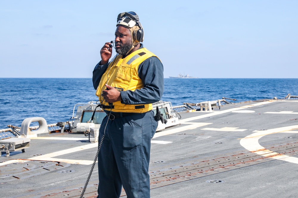 Sailors aboard the USS Howard conduct flight quarters in the North Pacific Sea