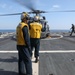 Sailors aboard the USS Howard conduct flight quarters in the North Pacific Sea