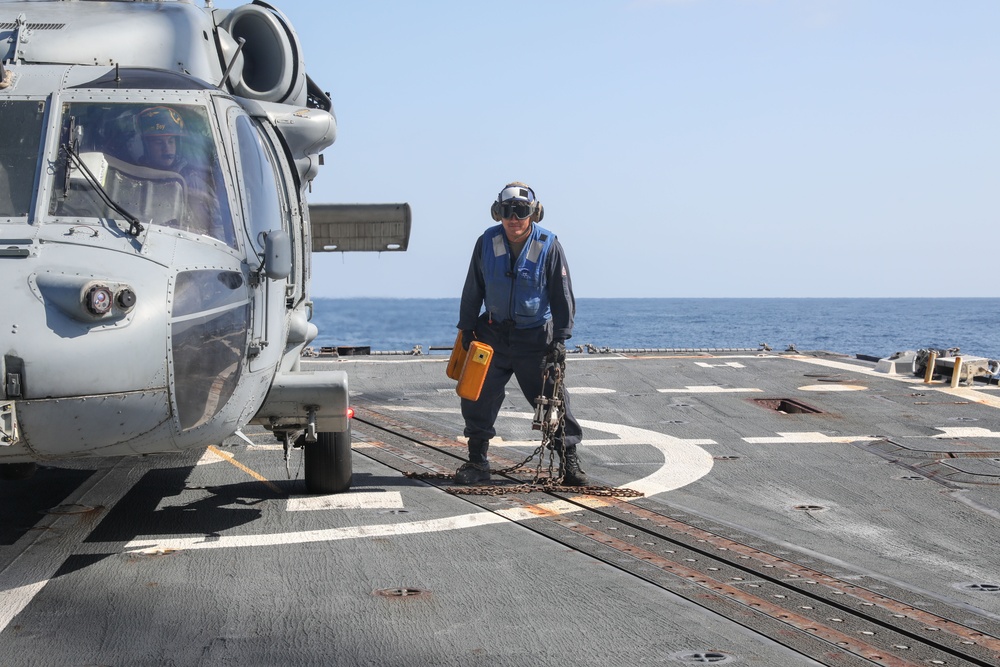 Sailors aboard the USS Howard conduct flight quarters in the North Pacific Sea