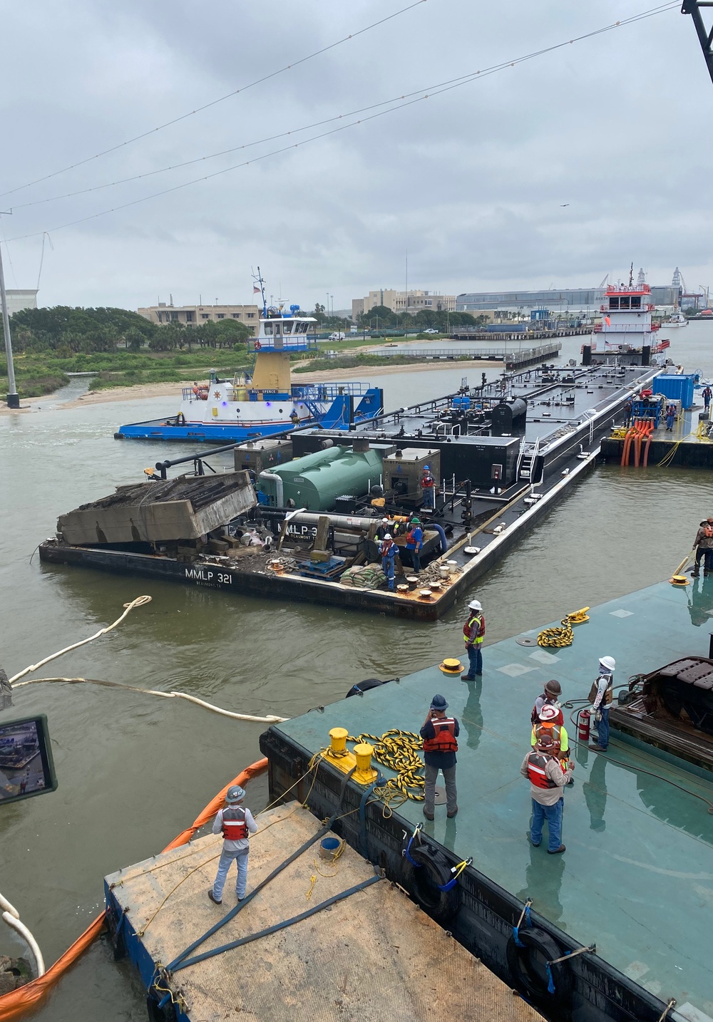 T&T Group personnel remove the barge MMLP 321 from beneath the Pelican Island Bridge near Galveston, Texas, May 17, 2024. No additional oil discharged during the barge’s removal. (U.S. Coast Guard photo, courtesy Texas General Land Office)