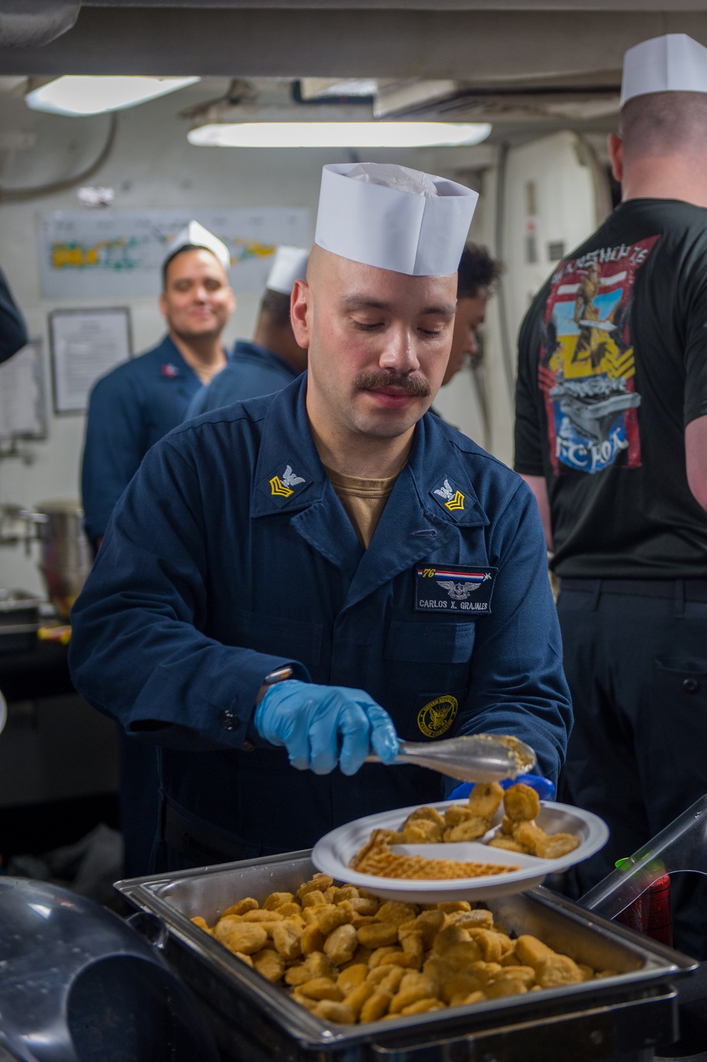 USS Ronald Reagan (CVN 76) Sailors serve brunch during holiday routine