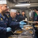 USS Ronald Reagan (CVN 76) Sailors serve brunch during holiday routine