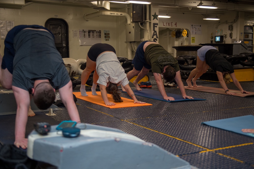 USS Ronald Reagan (CVN 76) Sailors participate in morning yoga class