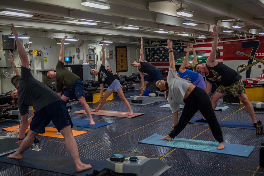 USS Ronald Reagan (CVN 76) Sailors participate in morning yoga class