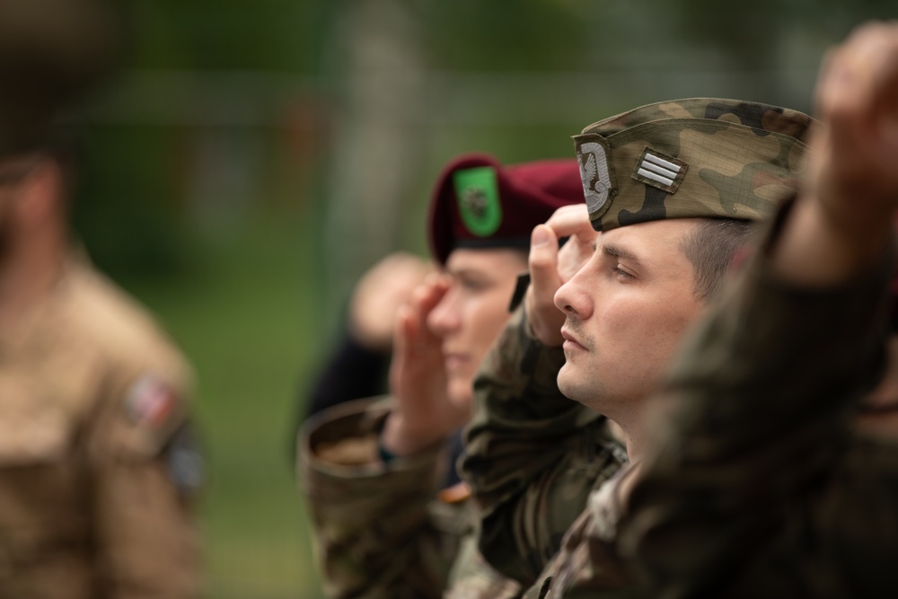 Dignitaries, members of 10th Special Forces Group (Airborne), Polish special forces, 6th Airborne Brigade, gather for the renaming of Camp Miron, May 17, 2024 near Krakow Poland.