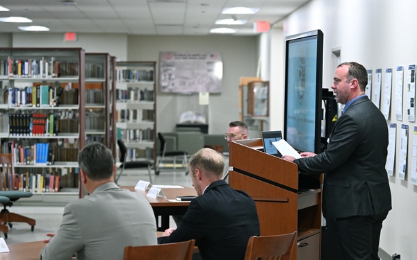 A student from the National Defense University, who is in the College of International Security Affairs Masters Program, delivers a speech during the Spring Symposium/Irregular Warfare Forum
