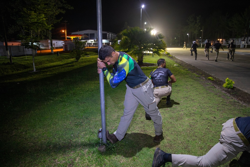 Competitors conduct Fuerzas Comando 24 Night Ruck March