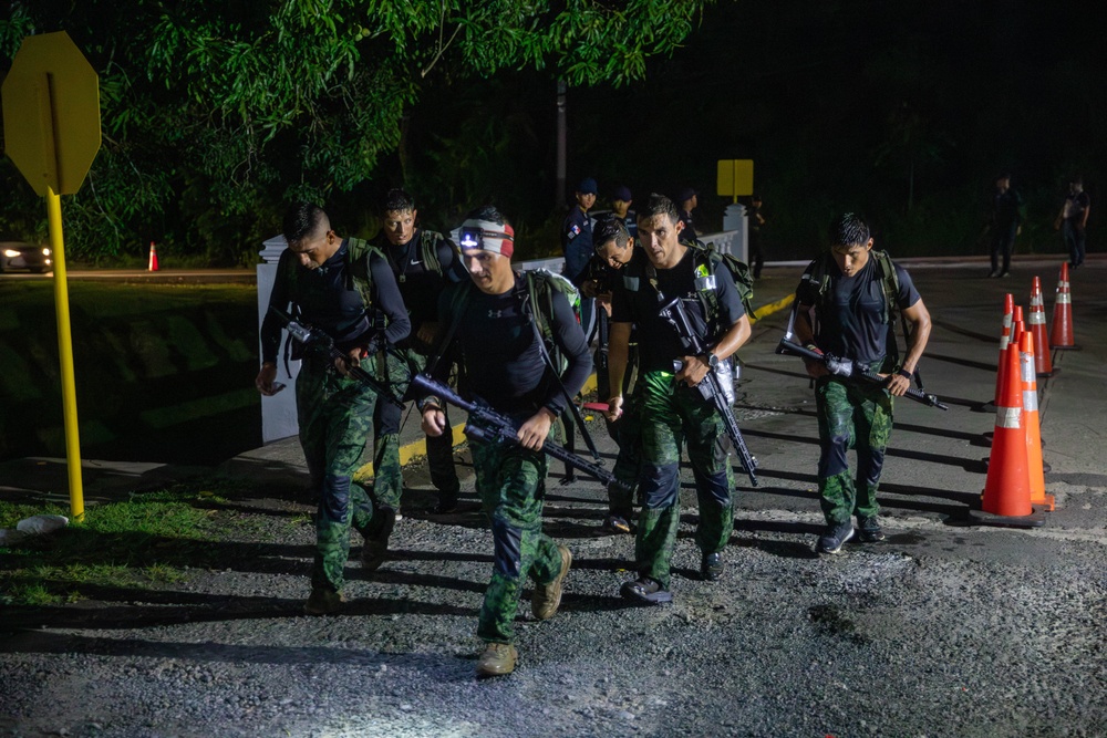 Competitors conduct Fuerzas Comando 24 Night Ruck March