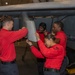 Sailors perform maintenance on aircraft aboard Abraham Lincoln
