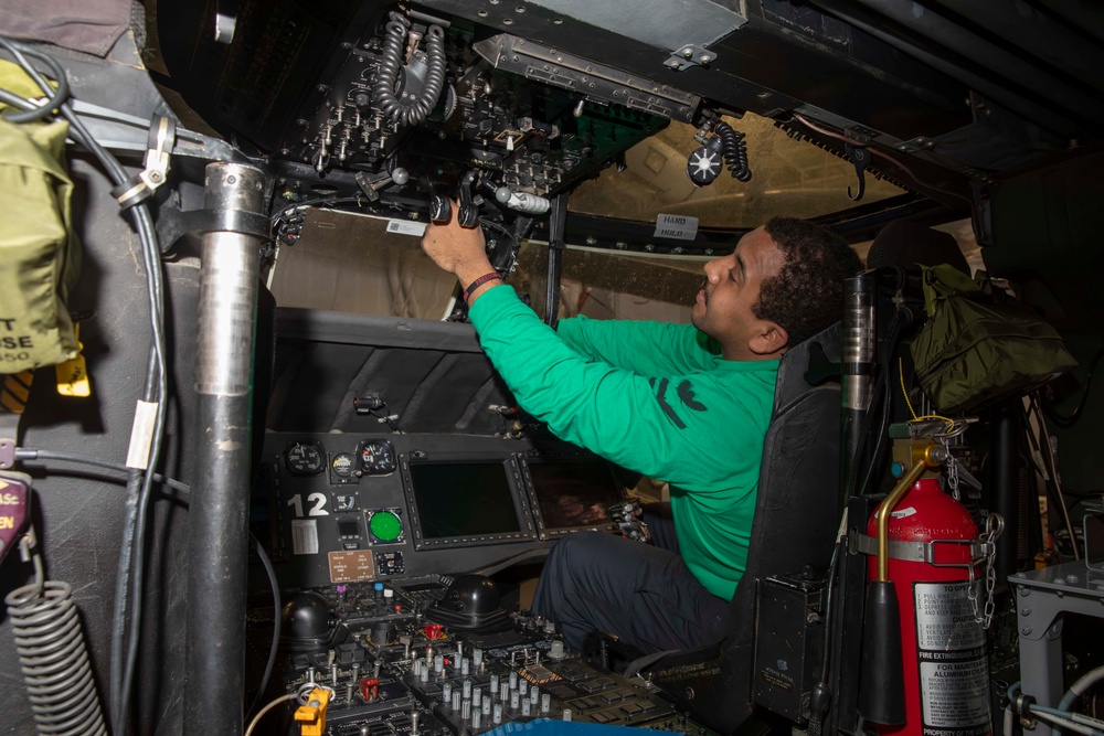 Sailors perform maintenance on aircraft aboard Abraham Lincoln