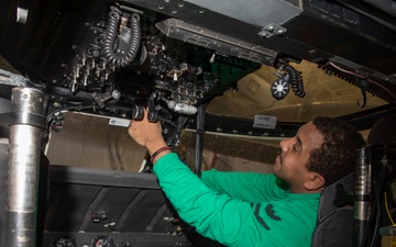 Sailors perform maintenance on aircraft aboard Abraham Lincoln